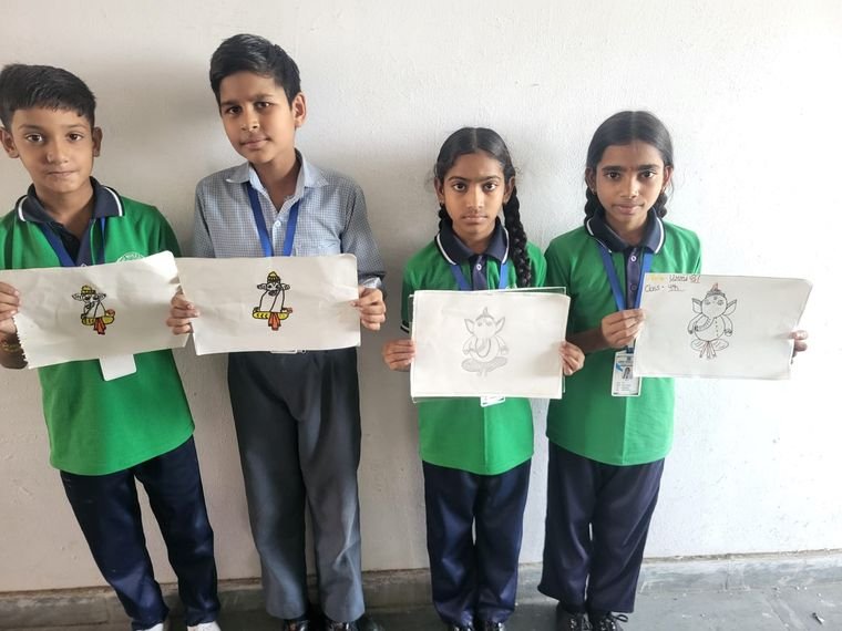 Students displaying their drawing competition entries at Janhit World School