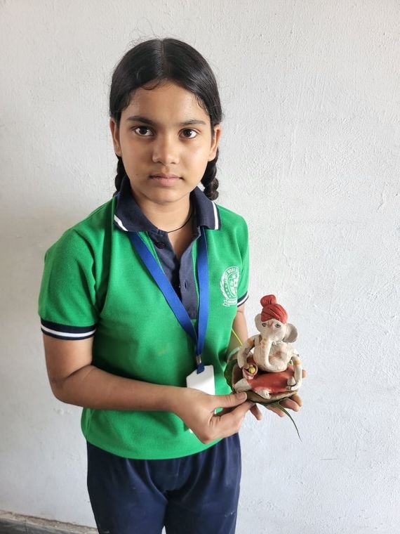 A student with her handmade clay idol at Janhit World School