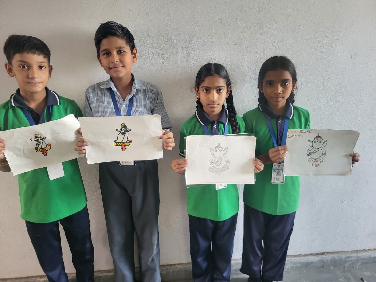 Students of Janhit World School holding their drawings at an art competition