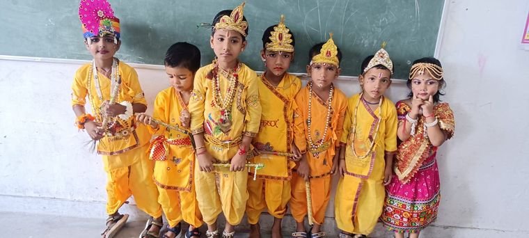 Kindergarten children dressed as Krishna for Janmashtami at Janhit World School